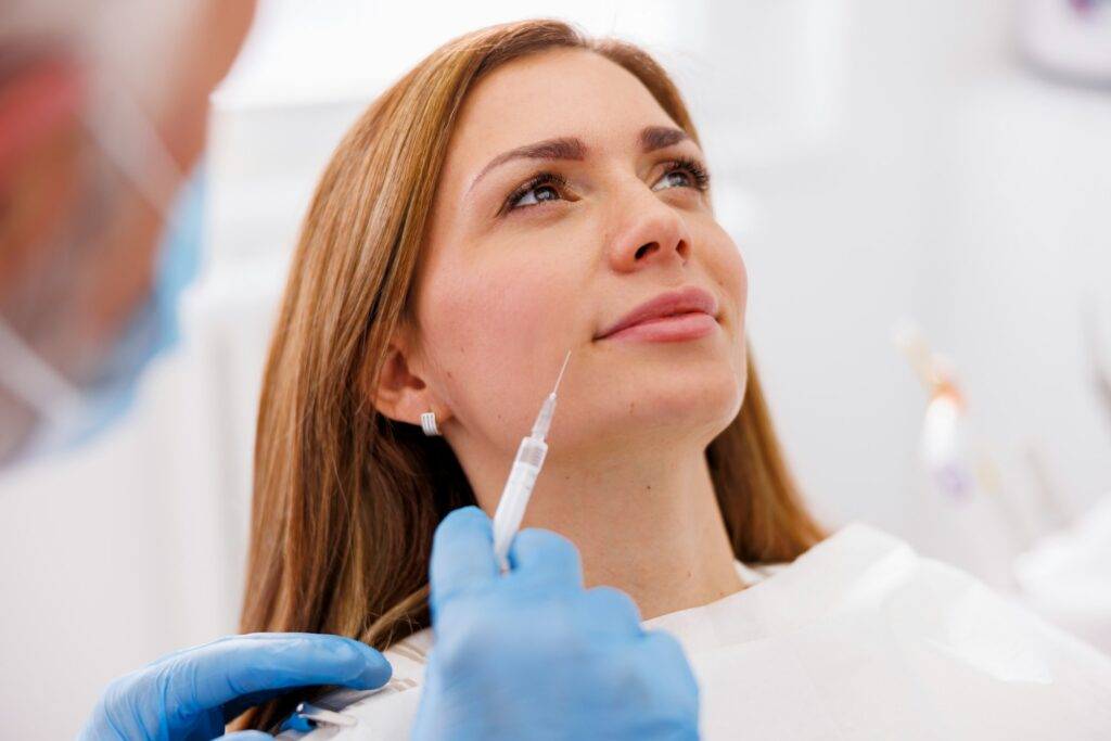 Doctor applying hyaluron fillers to patient